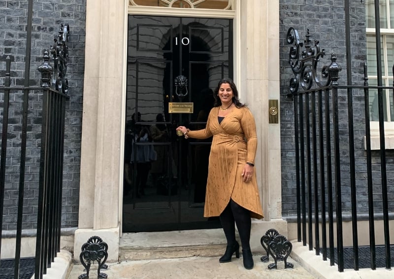 Rajinder standing outside of No 10 in Westminster, London. Image credit: Rajinder Pryor MBE