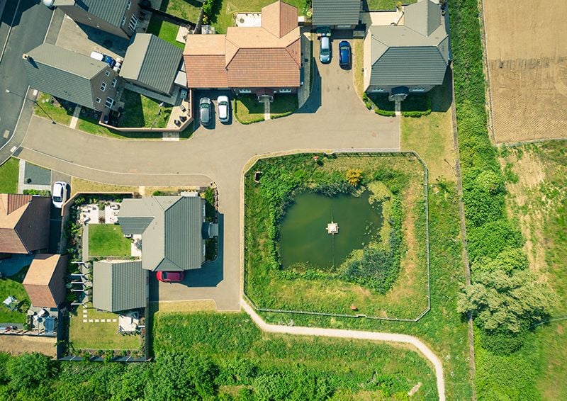 An attenuation pond in a housing development. Image credit: Shutterstock