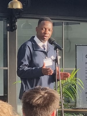 Thabani Manjengwa delivering a presentation while wearing a navy jacket.