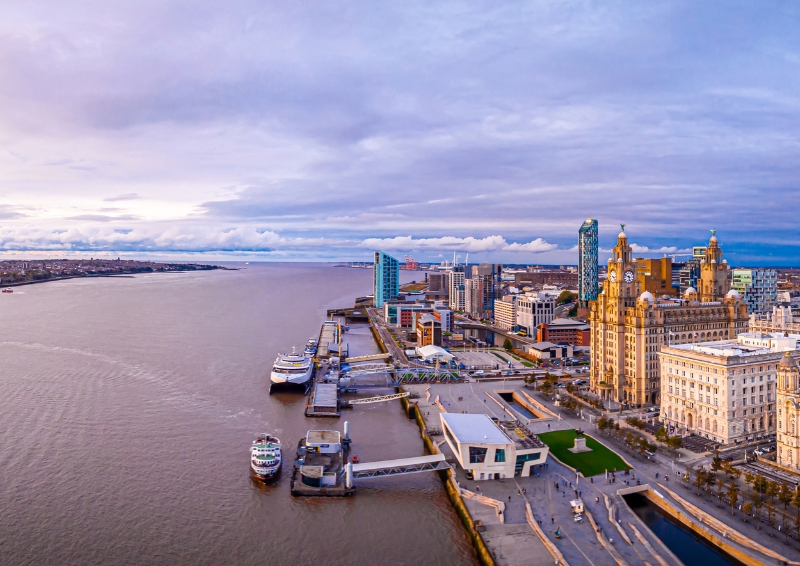 A panorama photograph of the River Mersey in Liverpool, UK on a cloudy day. 