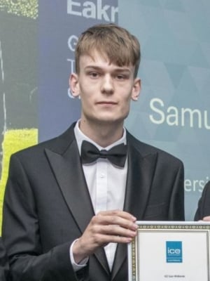 A portrait of Samuel Szczepanski in a suit